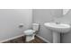 Simple bathroom with pedestal sink and wood-look tile floor at 21160 E Cattle Dr, Queen Creek, AZ 85142