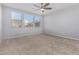 Bright bedroom with ceiling fan and neutral carpeting at 21160 E Cattle Dr, Queen Creek, AZ 85142