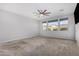 Bright bedroom with neutral carpeting and ceiling fan at 21160 E Cattle Dr, Queen Creek, AZ 85142