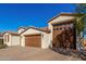 Attractive single-story home with a three-car garage and desert landscaping at 21160 E Cattle Dr, Queen Creek, AZ 85142