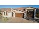 Two-story home with a brown garage door and light-colored exterior at 21160 E Cattle Dr, Queen Creek, AZ 85142