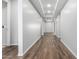 Bright hallway with wood-look tile flooring and neutral walls at 21160 E Cattle Dr, Queen Creek, AZ 85142