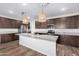 Spacious kitchen featuring granite countertops and dark wood cabinets at 21160 E Cattle Dr, Queen Creek, AZ 85142