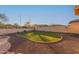 Landscaped backyard with artificial turf and rock at 213 E Summerside Rd, Phoenix, AZ 85042