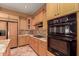 Bright kitchen with double ovens, gas cooktop and granite countertops at 213 E Summerside Rd, Phoenix, AZ 85042