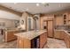 Kitchen boasts granite island, stainless steel appliances, and ample cabinetry at 213 E Summerside Rd, Phoenix, AZ 85042