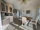 Kitchen dining area with a round wooden table and white chairs at 2358 S Pomo Ave, Apache Junction, AZ 85119