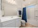 Clean bathroom boasts white vanity, shower/tub combo, and blue accents at 2413 E Alta Vista Rd, Phoenix, AZ 85042