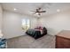 Bright bedroom with double bed, ceiling fan, and window at 2413 E Alta Vista Rd, Phoenix, AZ 85042