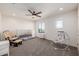 Bedroom with crib, rocker, and ceiling fan at 2413 E Alta Vista Rd, Phoenix, AZ 85042