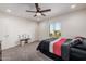 Bright bedroom with double bed, ceiling fan, and window at 2413 E Alta Vista Rd, Phoenix, AZ 85042