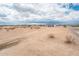 Wide-open lot with scattered desert vegetation, offering expansive space for new construction at 25505 W Brookhart Way, Wittmann, AZ 85361