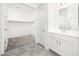 Bathroom with a single vanity and connected walk-in closet for convenient storage and functionality at 25505 W Brookhart Way, Wittmann, AZ 85361