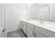 Modern bathroom featuring double sinks and white cabinets, offering a clean and functional design at 25505 W Brookhart Way, Wittmann, AZ 85361
