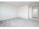 Spacious carpeted bedroom with neutral tones, offering a blank canvas for personalization at 25505 W Brookhart Way, Wittmann, AZ 85361