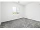 Bright bedroom with large window offering a view, carpeted and ready for personalization at 25505 W Brookhart Way, Wittmann, AZ 85361