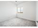 Empty bedroom with plush carpet, large window, and an airy feel, perfect for relaxation at 25505 W Brookhart Way, Wittmann, AZ 85361