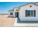 Close up of a single-story home with a dark front door, gray shutters, and desert landscaping at 25505 W Brookhart Way, Wittmann, AZ 85361