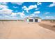 Wide angle of new construction white stucco home featuring a three-car garage at 25505 W Brookhart Way, Wittmann, AZ 85361