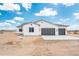 A three-car garage enhances this inviting white stucco home with desert landscaping at 25505 W Brookhart Way, Wittmann, AZ 85361