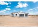 Charming white stucco home featuring a three-car garage and desert landscape at 25505 W Brookhart Way, Wittmann, AZ 85361