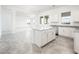 Gourmet kitchen with island, white cabinetry, stainless steel appliances and plenty of natural light at 25505 W Brookhart Way, Wittmann, AZ 85361