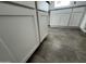 Low-angle shot of the white kitchen cabinets paired with gray tiled floors at 25505 W Brookhart Way, Wittmann, AZ 85361