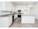 Well-lit kitchen with stainless steel appliances and white cabinets at 25505 W Brookhart Way, Wittmann, AZ 85361
