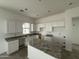 Modern kitchen featuring white cabinets and granite countertops on island and perimeter at 25505 W Brookhart Way, Wittmann, AZ 85361