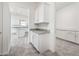 Stylish kitchenette with white cabinets and granite countertops, seamlessly connecting to a hallway at 25505 W Brookhart Way, Wittmann, AZ 85361