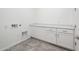 Well-lit laundry room with utility connections and white cabinets, providing convenience and storage at 25505 W Brookhart Way, Wittmann, AZ 85361