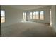 Spacious living room with natural light pouring in through large windows at 25505 W Brookhart Way, Wittmann, AZ 85361