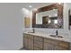 Bathroom with double sinks, granite countertop, and copper faucets at 2731 E Laurel Ln, Phoenix, AZ 85028