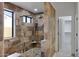 Large walk-in shower with stone tile and pebble floor at 2731 E Laurel Ln, Phoenix, AZ 85028