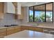 Kitchen with gas cooktop, wood cabinets, and a tile backsplash at 2731 E Laurel Ln, Phoenix, AZ 85028