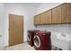 Laundry room with washer, dryer, and a utility sink at 2731 E Laurel Ln, Phoenix, AZ 85028