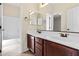 Bathroom featuring double sinks and a bathtub with a white tile surround at 2742 N Augustine --, Mesa, AZ 85207