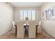 Dining room features plantation shutters, neutral walls, and a wooden table with seating for six at 2742 N Augustine --, Mesa, AZ 85207