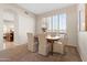 Cozy dining room features plantation shutters and neutral walls adjacent to another living space at 2742 N Augustine --, Mesa, AZ 85207