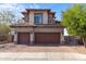 Charming two-story home with a tiled roof, stone accents, a brick driveway, and a two-car garage at 2742 N Augustine --, Mesa, AZ 85207