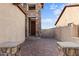 A brick courtyard with stone pillars leads to the front door of this beige home at 2742 N Augustine --, Mesa, AZ 85207