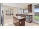 Well-lit kitchen featuring dark wood cabinets, granite countertops, an island, and stainless steel appliances at 2742 N Augustine --, Mesa, AZ 85207