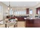 Kitchen and dining area featuring dark cabinetry, granite countertops, and plantation shutters at 2742 N Augustine --, Mesa, AZ 85207