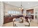 Kitchen and dining area with dark wood cabinetry and matching island; plantation shutters for light control at 2742 N Augustine --, Mesa, AZ 85207