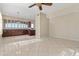 Bright living room features tile floors, plantation shutters and a ceiling fan at 2742 N Augustine --, Mesa, AZ 85207