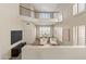 A balcony overlooking a bright living room with high ceilings and plantation shutters next to an adjacent dining room at 2742 N Augustine --, Mesa, AZ 85207
