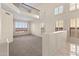 Bright, open-concept living space with a view of the second-story balcony and large shuttered windows at 2742 N Augustine --, Mesa, AZ 85207