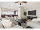 Bright living room with neutral color palette, modern furniture, ceiling fan, and view into kitchen area at 2742 N Augustine --, Mesa, AZ 85207