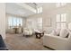 Bright living room with high ceilings and multiple windows with plantation shutters leads into an adjacent dining room at 2742 N Augustine --, Mesa, AZ 85207