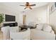 Neutral-toned living room features a ceiling fan, stylish decor, comfortable seating, and tiled flooring at 2742 N Augustine --, Mesa, AZ 85207